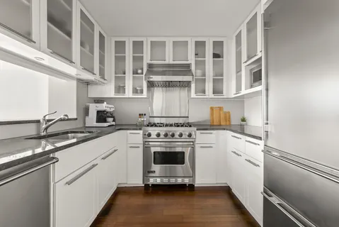 a kitchen with a stove oven and sink