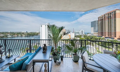a balcony with wooden floor and outdoor seating