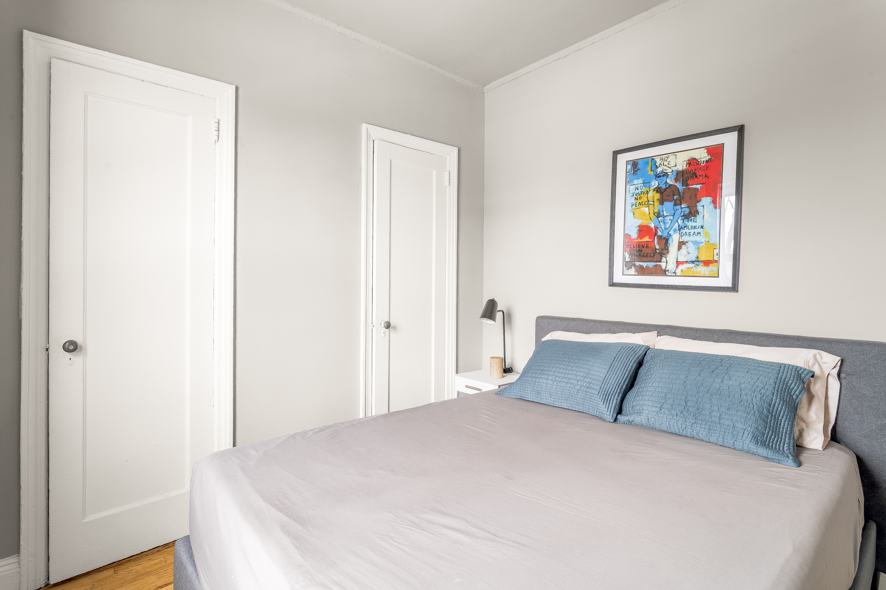 94 Hamilton Place, Unit 6E Manhattan, NY 10031 - Photo 10 of 16 a bedroom with a large bed and a painting on the wall