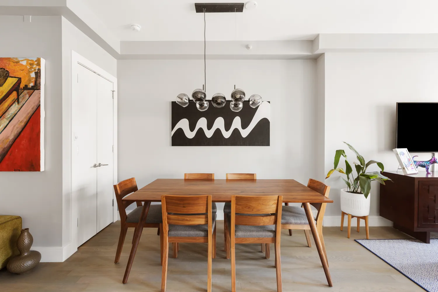 a view of a dining room with furniture and wooden floor