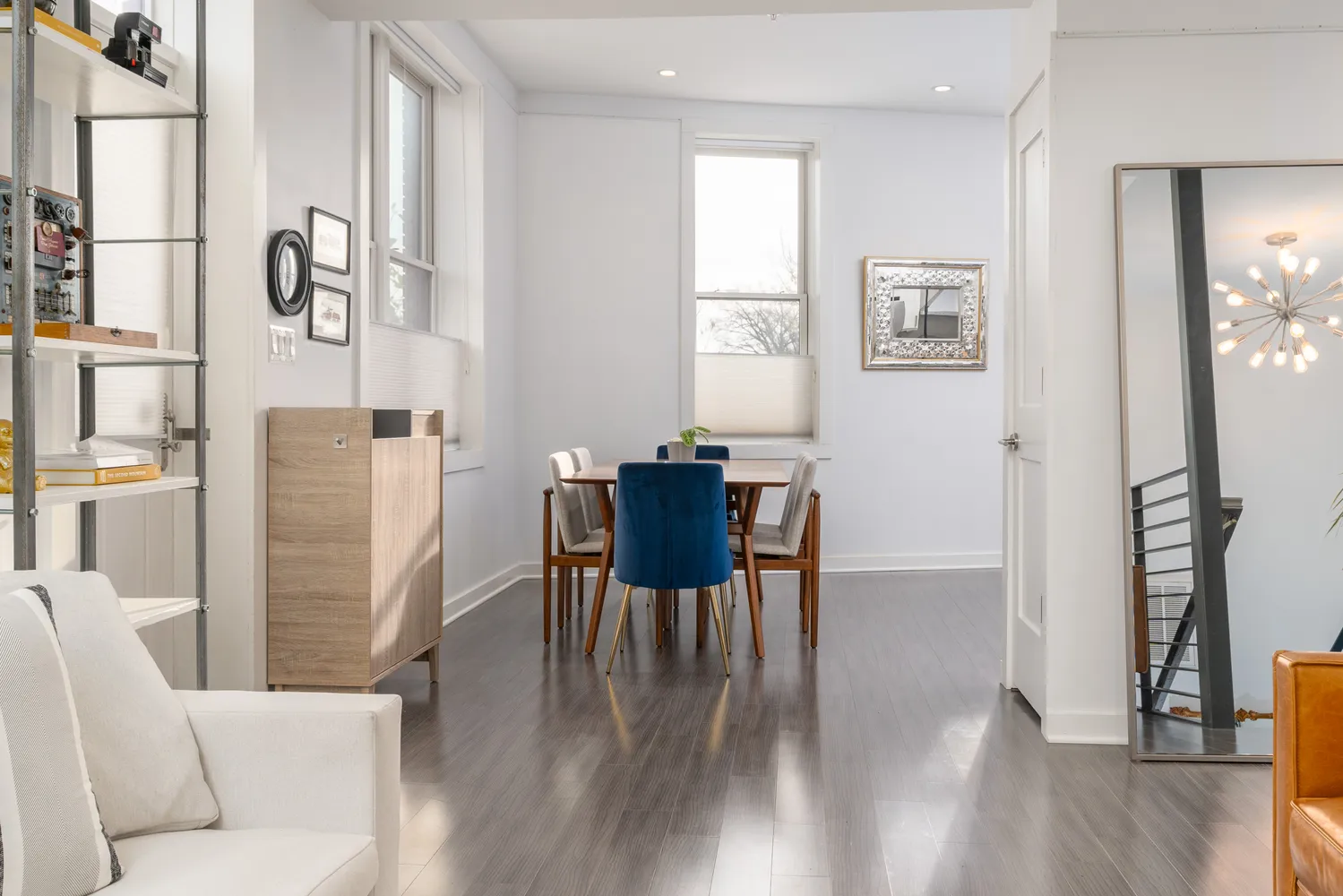 a dining room with furniture and wooden floor