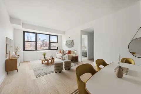 a bedroom with two beds and a large window