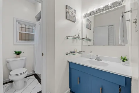 a bedroom with a large bed wooden floor and window
