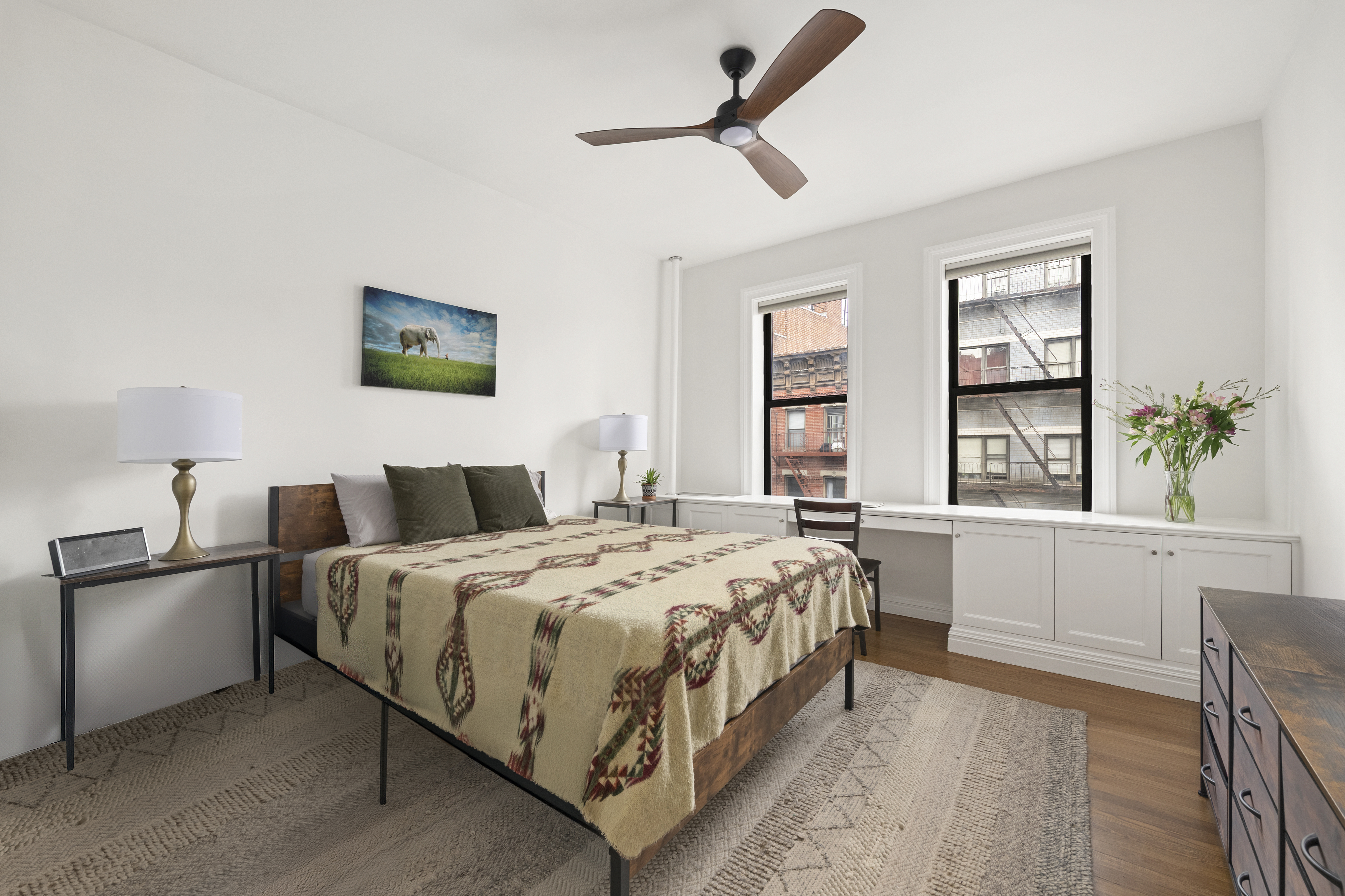 222 East 82nd Street, Unit 5E Manhattan, NY 10028 - Photo 6 of 10 a bedroom with a bed and a large window