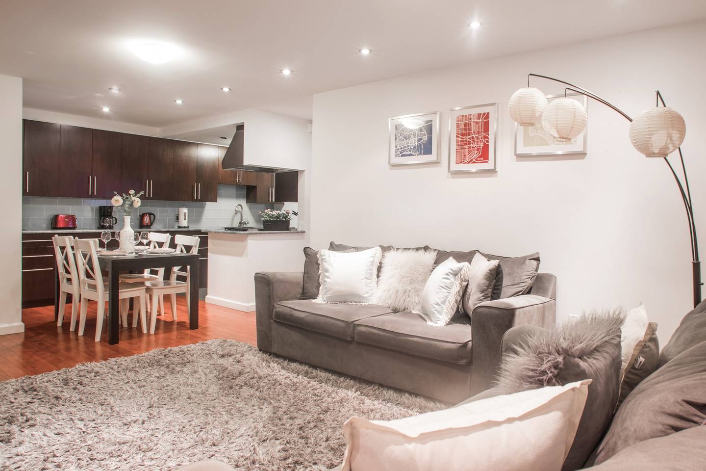 153 Stanton Street, Unit A1 Manhattan, NY 10002 - Photo 6 of 16 a living room with furniture and a dining area with kitchen view