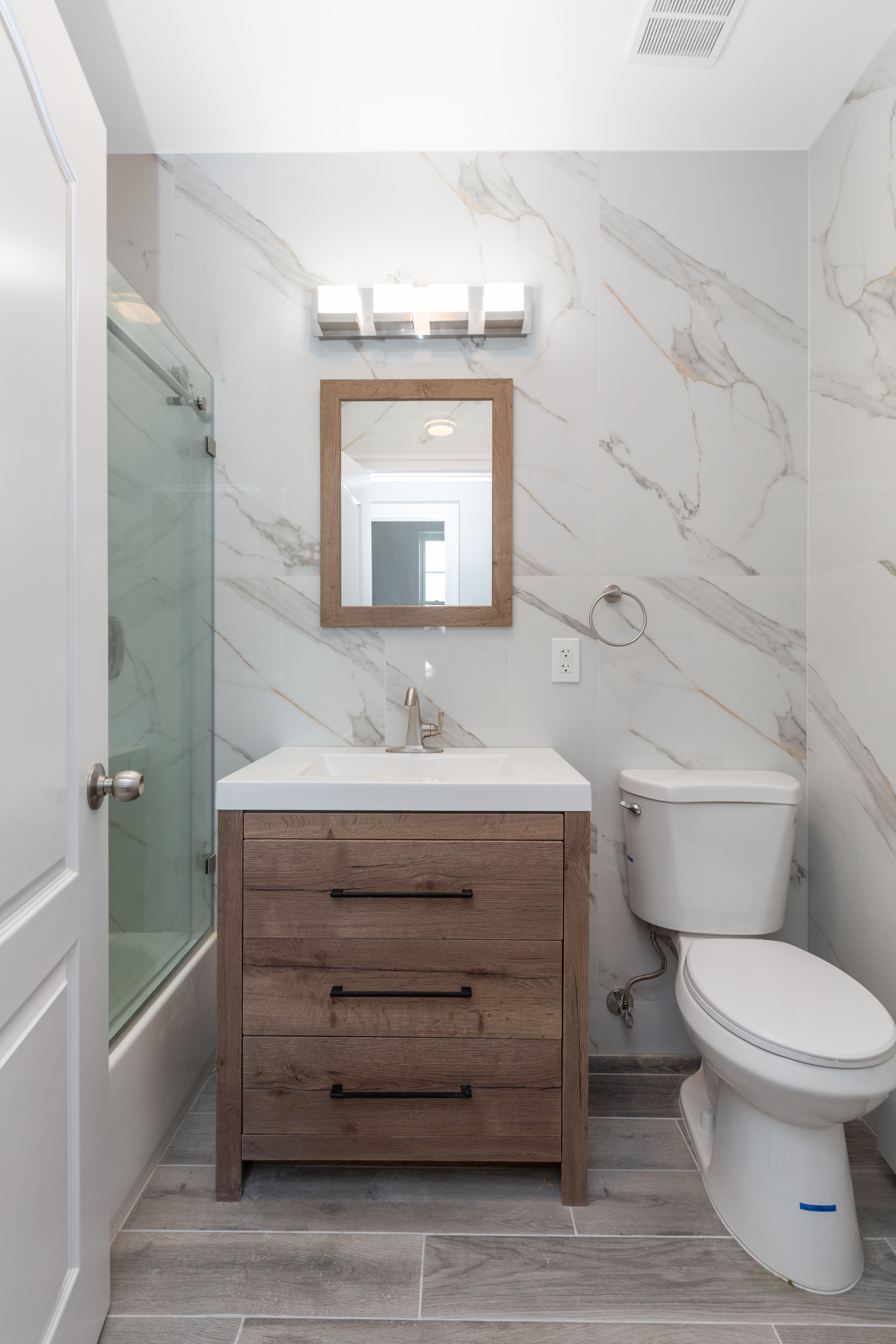 143-10 Shore Avenue Queens, NY 11435 - Photo 12 of 30 a bathroom with a toilet a sink and mirror