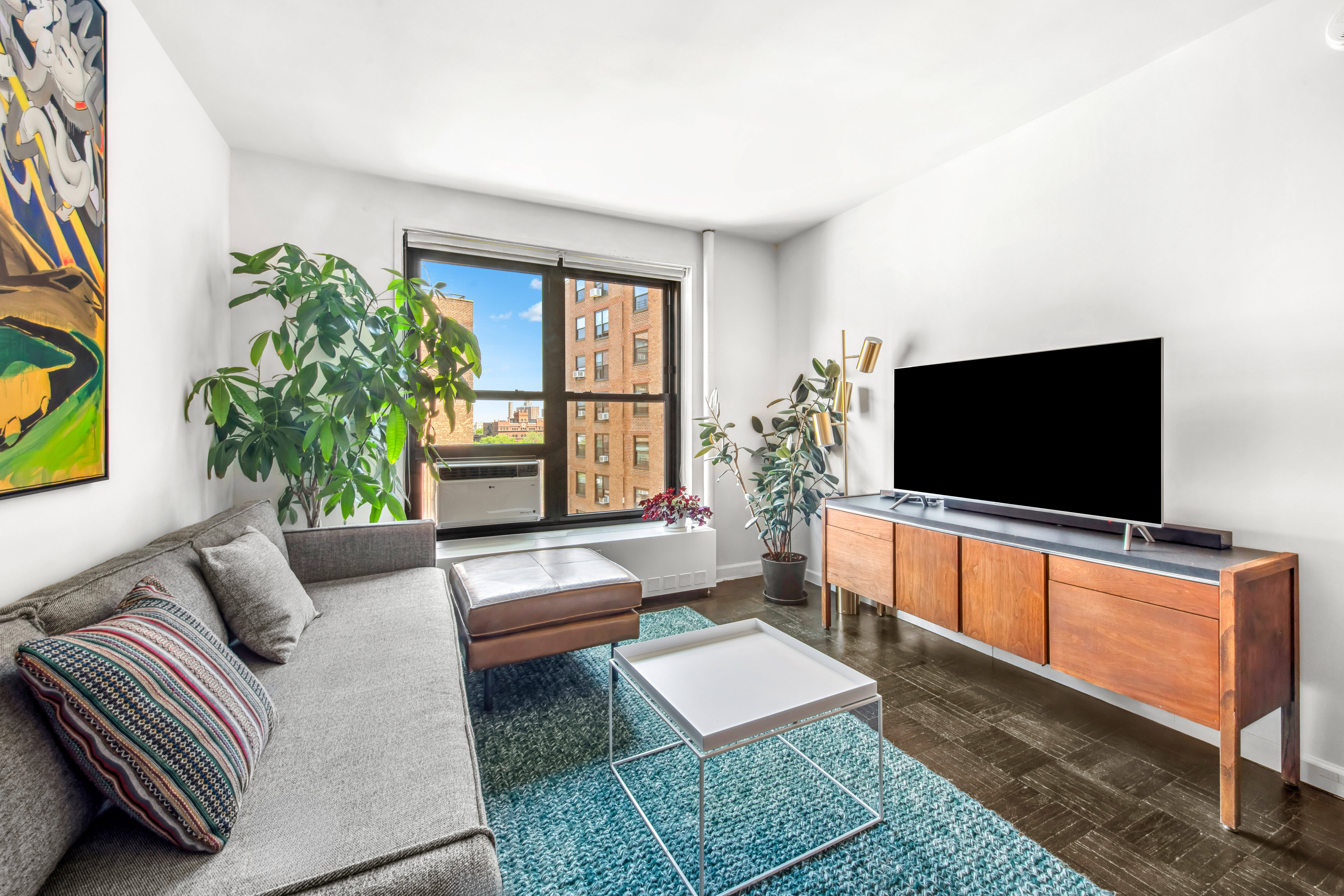 201 Clinton Avenue, Unit 10F Brooklyn, NY 11205 - Photo 3 of 11 a living room with furniture and a flat screen tv