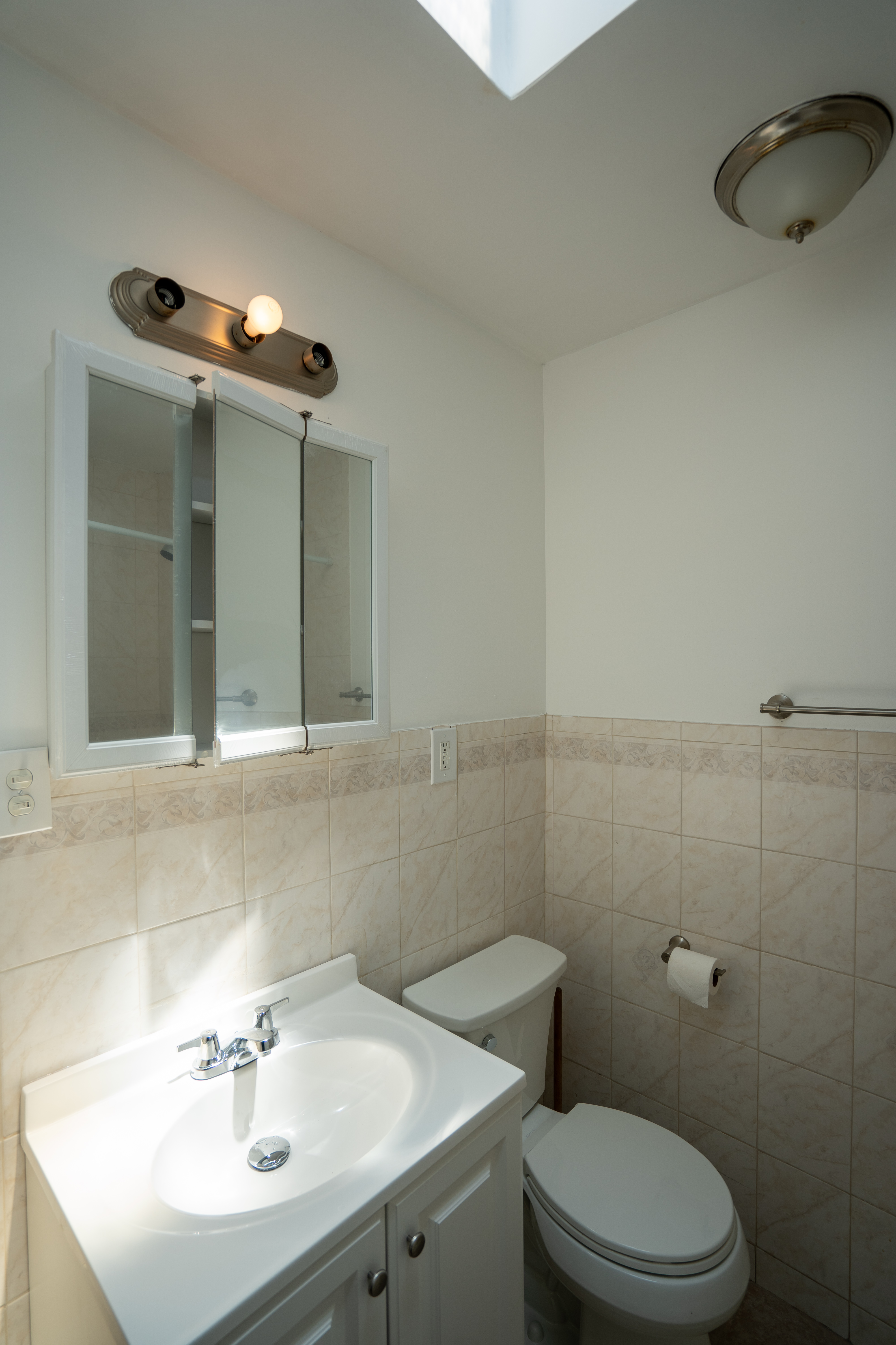 1379 Pacific Street, Unit 4 Brooklyn, NY 11216 - Photo 6 of 8 a bathroom with a sink a toilet and mirror