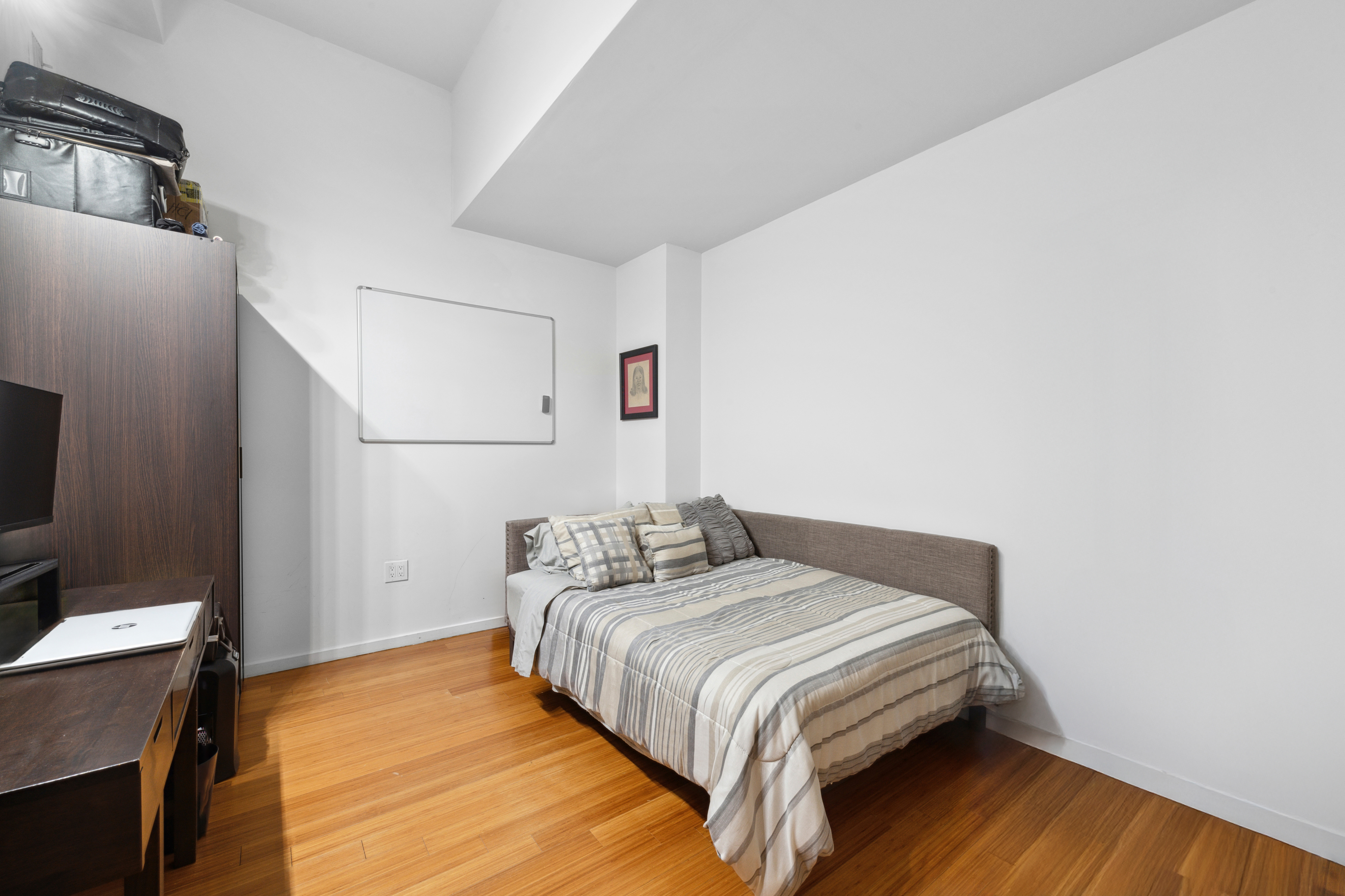 365 Bridge Street, Unit 12H Brooklyn, NY 11201 - Photo 9 of 12 a bedroom with a bed and a flat screen tv