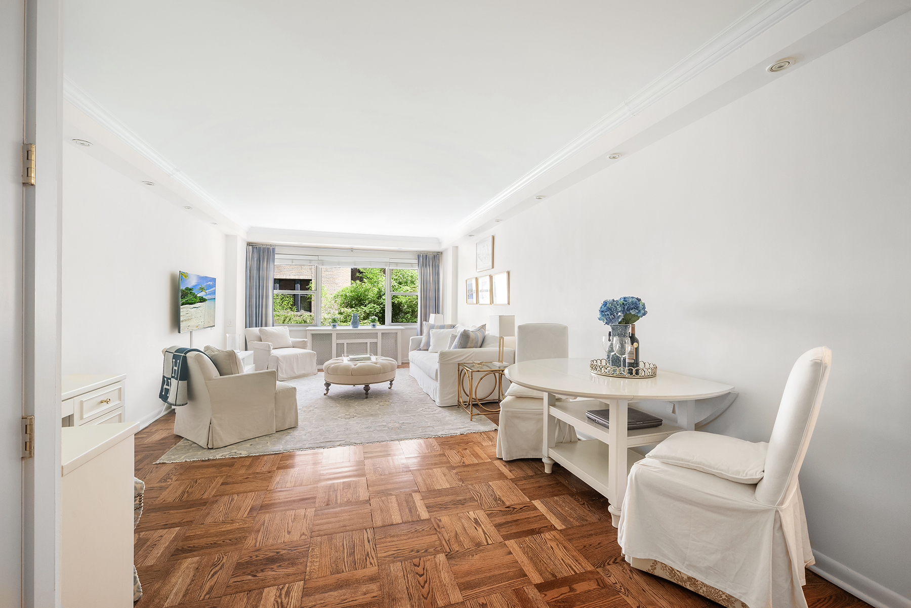 311 East 71st Street, Unit 2B Manhattan, NY 10021 - Photo 3 of 10 a living room with furniture and a large window
