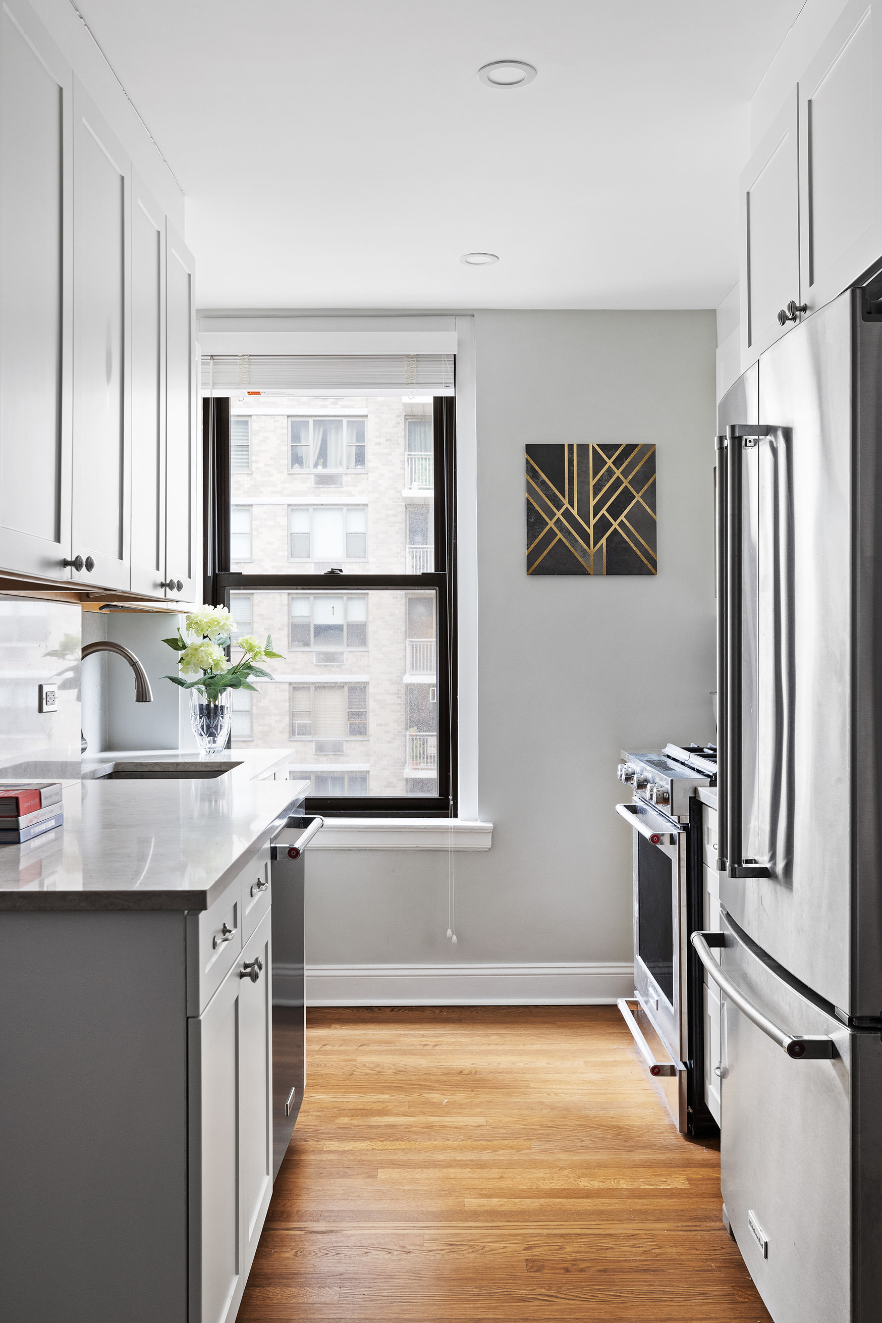 308 East 79th Street, Unit 9E Manhattan, NY 10075 - Photo 3 of 7 a kitchen with stainless steel appliances granite countertop a sink stove and refrigerator