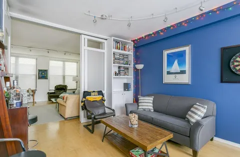 a living room with furniture gym equipment and a flat screen tv