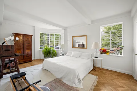 a bedroom with a large bed and a flat screen tv