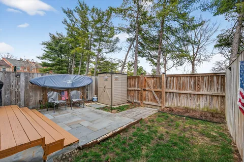 a side view of a house with a backyard