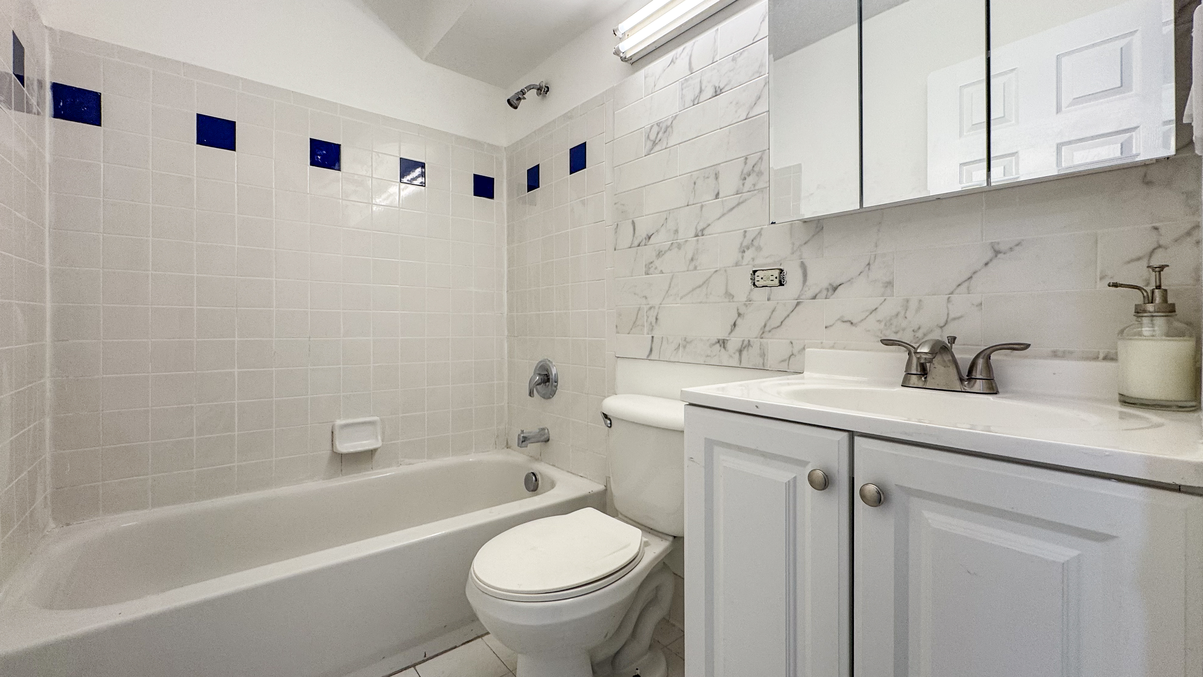 175 Eldert Street, Unit 1 Brooklyn, NY 11207 - Photo 7 of 12 a bathroom with a sink a toilet and bathtub