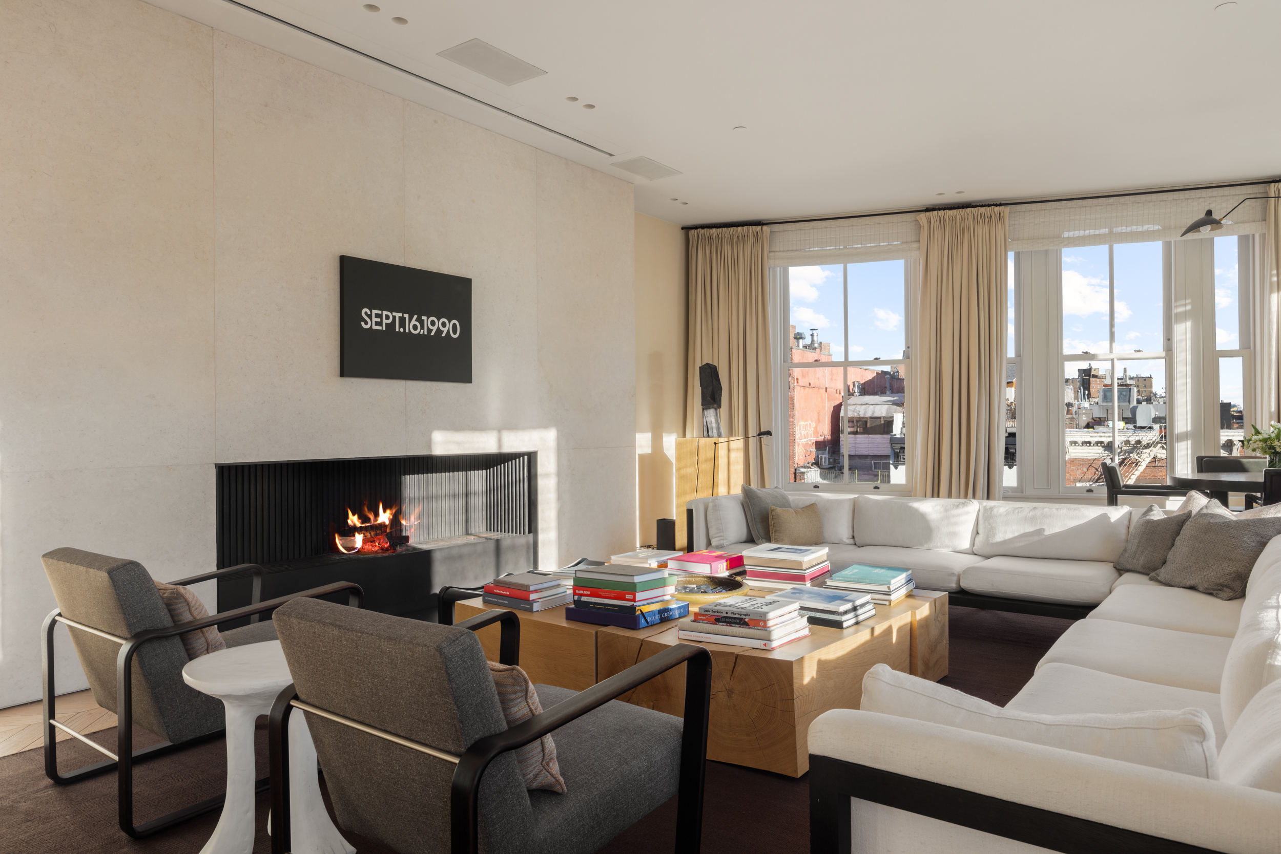 54 Bond Street, Unit PH Manhattan, NY 10012 - Photo 3 of 31 a living room with furniture a large window and a fireplace