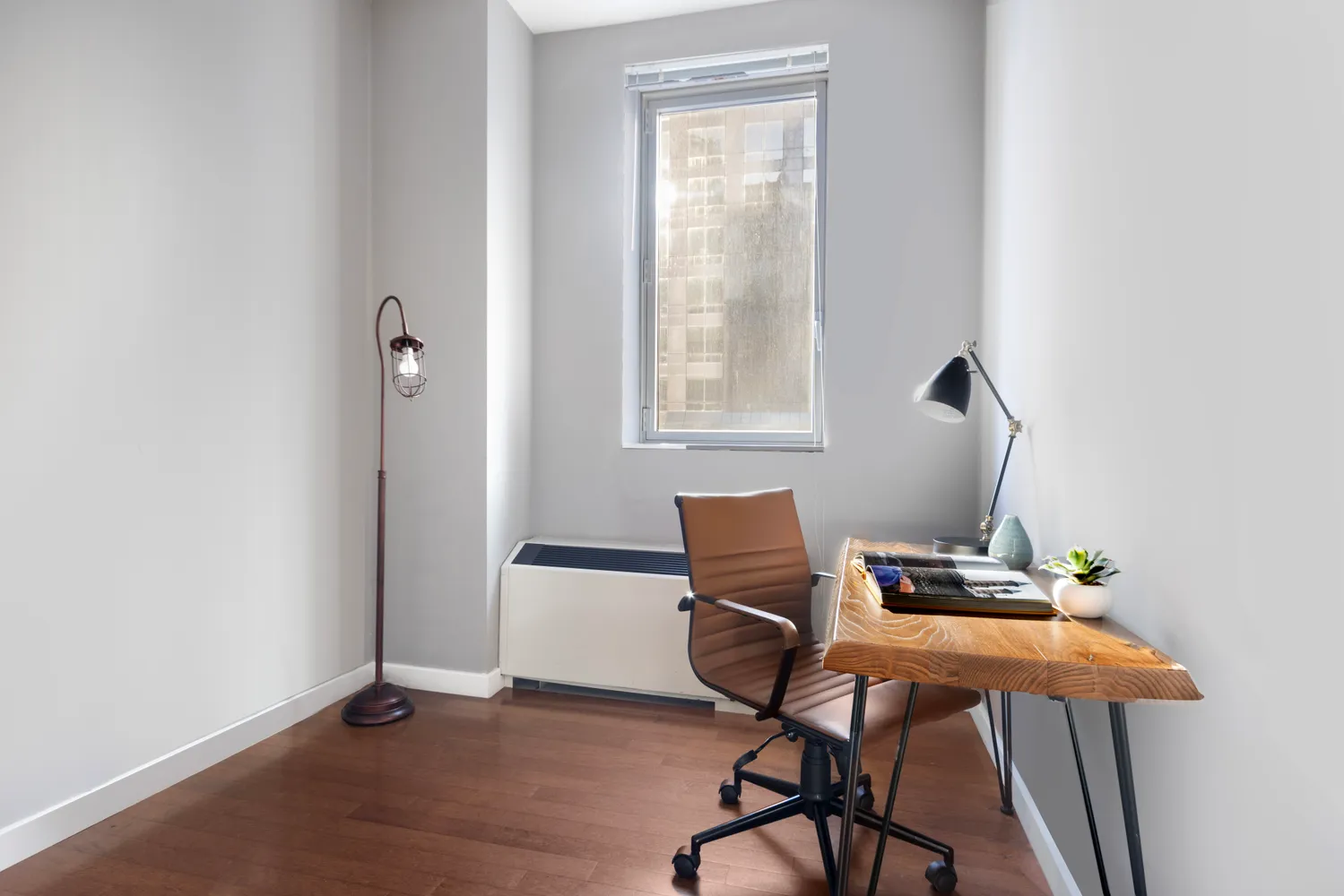 a workspace with furniture and a window