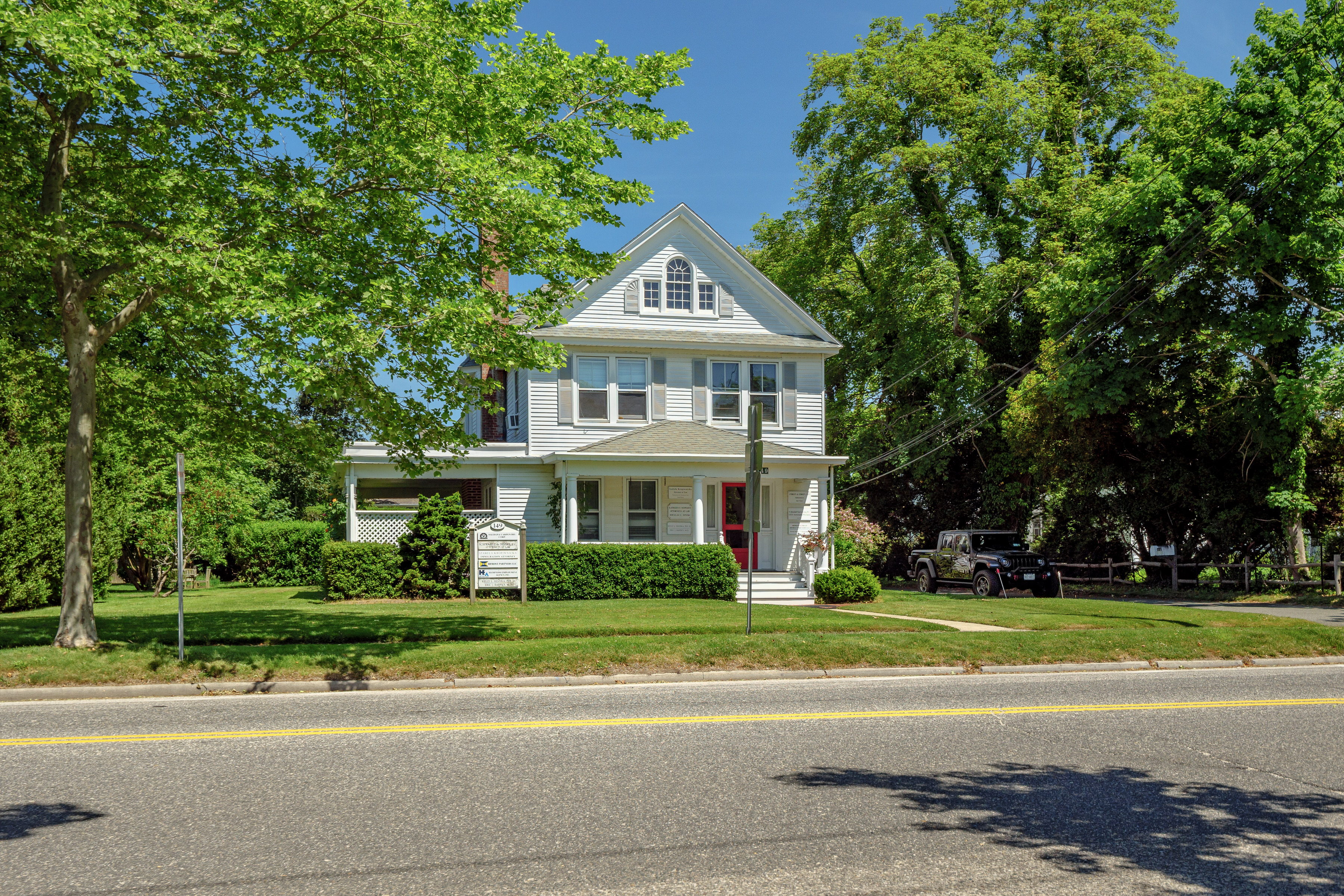 149 Hampton Road Southampton, NY 11968 - Photo 3 of 19 a front view of a house with a garden