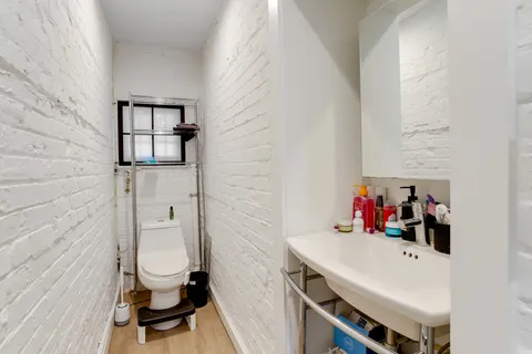 a view of a hallway with furniture and stairs