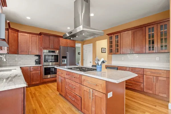 a kitchen with stainless steel appliances granite countertop a sink stove and refrigerator