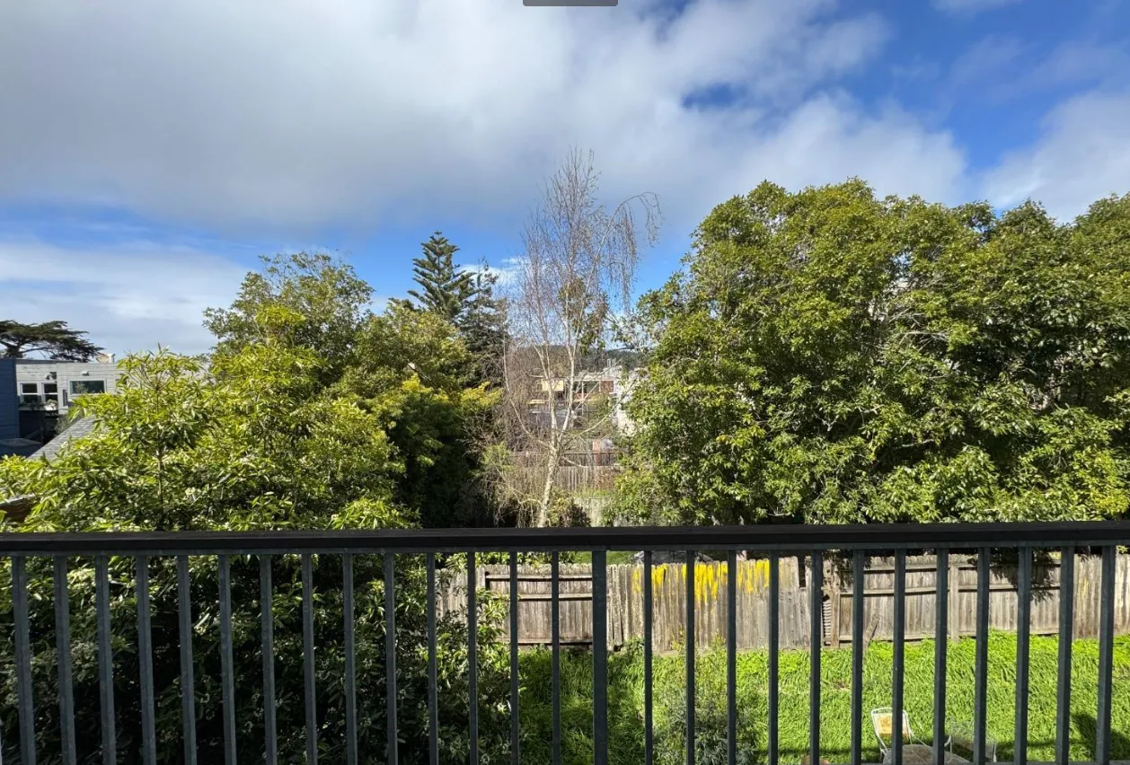 a view of a balcony with wooden floor