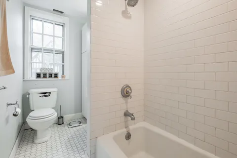 a bathroom with a toilet and a bathtub