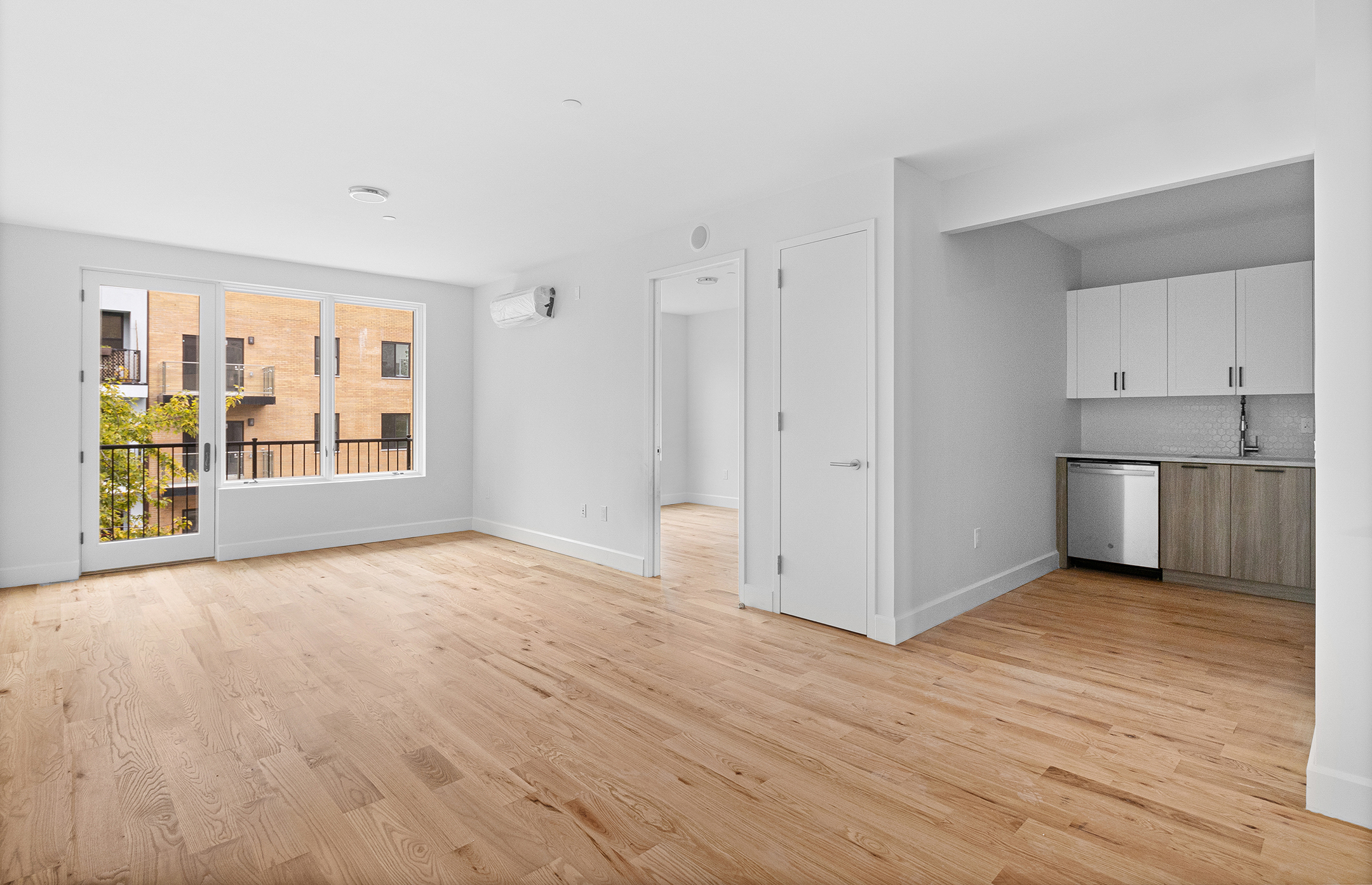1098 Madison Street, Unit 4B Brooklyn, NY 11221 - Photo 1 of 11 a view of an empty room with a kitchen and a window