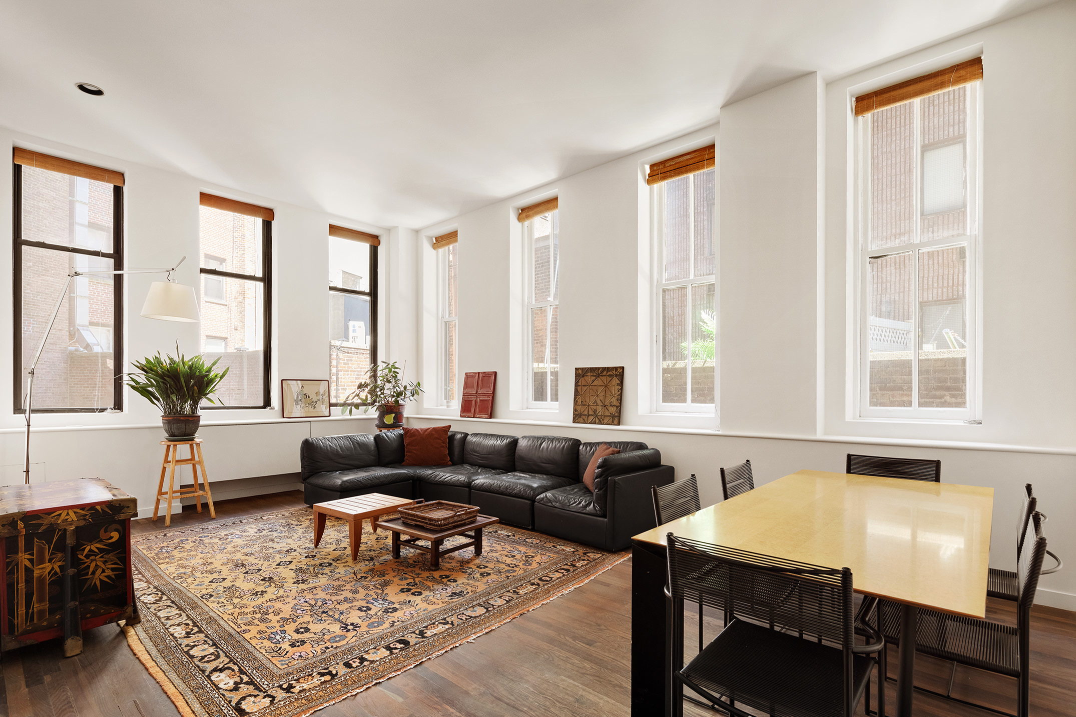 115 4th Avenue, Unit 2I Manhattan, NY 10003 - Photo 2 of 12 a living room with furniture and large windows