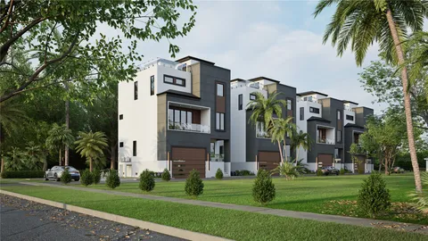 a multi story building with a yard and a palm tree