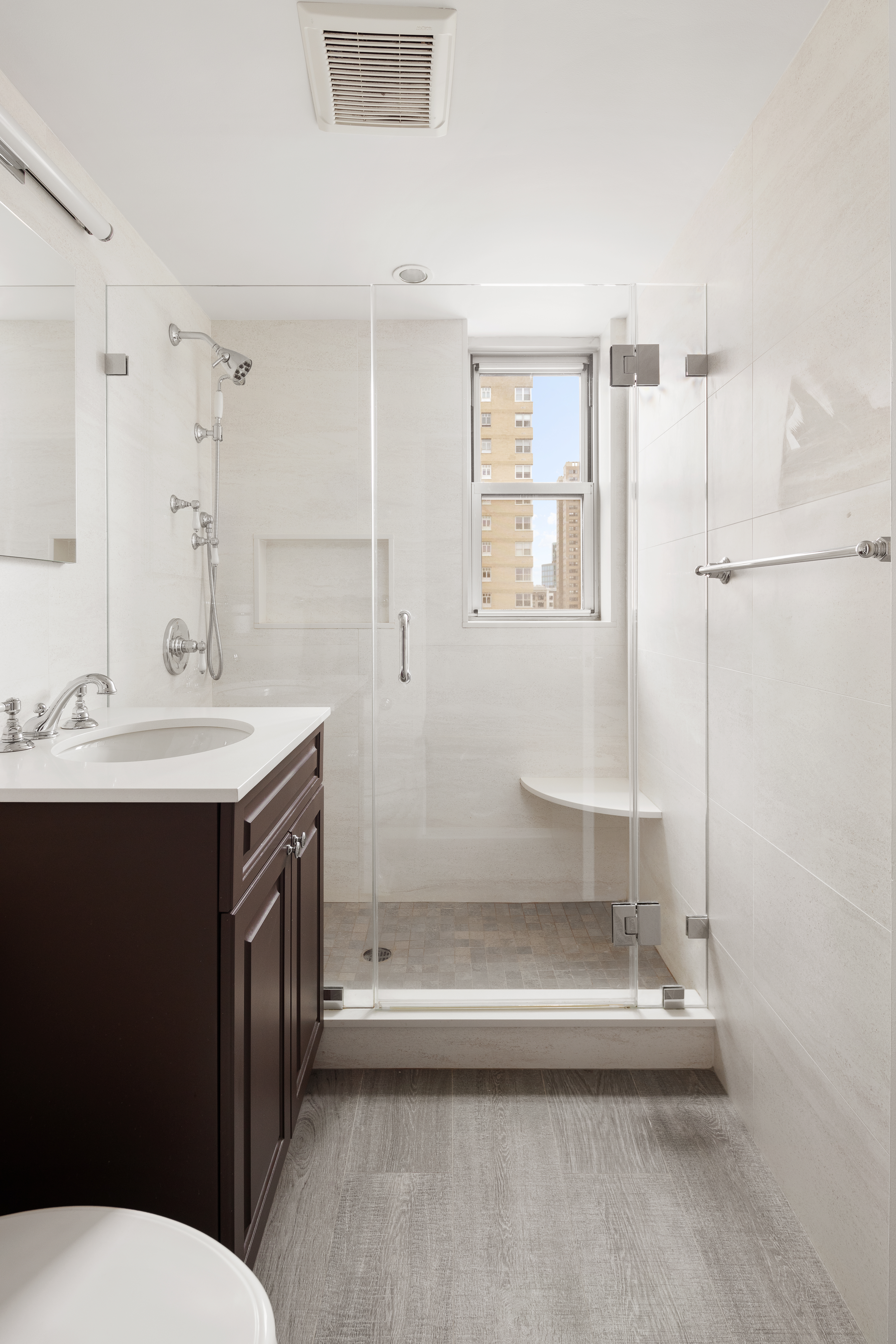 11 5th Avenue, Unit 18A Manhattan, NY 10003 - Photo 5 of 11 a bathroom with a sink a toilet and shower