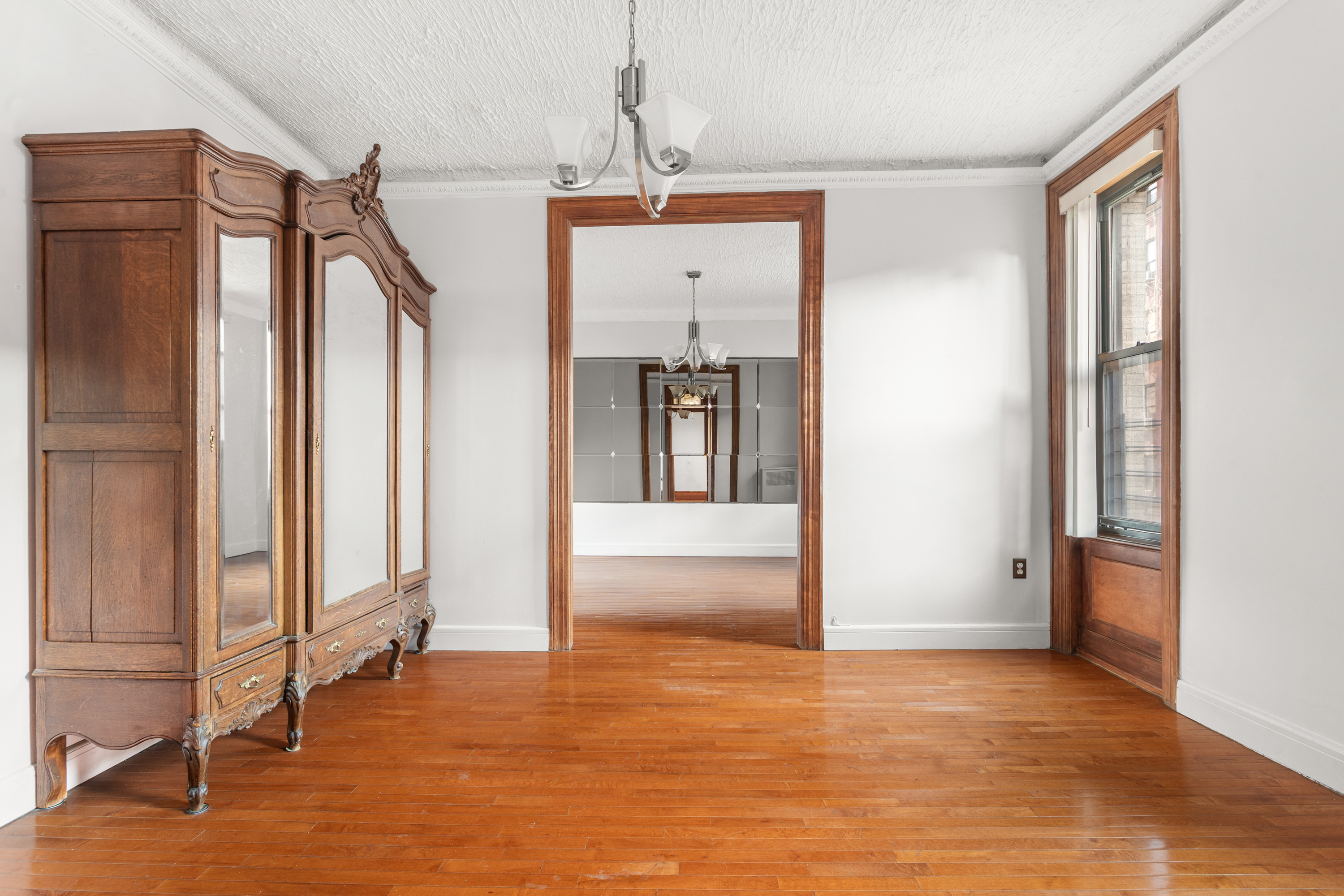 527 West 143rd Street, Unit 31 Manhattan, NY 10031 - Photo 5 of 29 a view of a room with wooden floor and windows