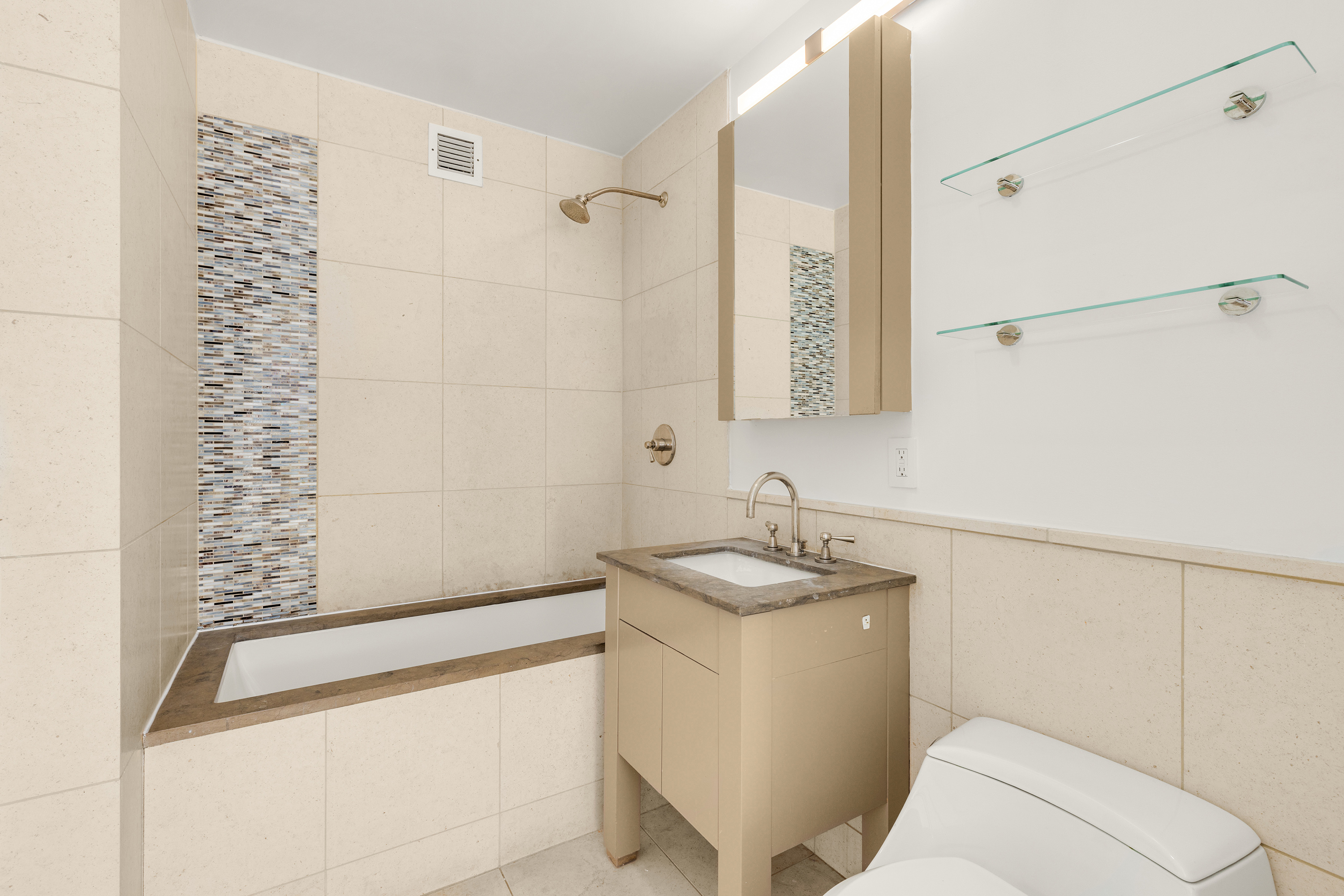 350 West 42nd Street, Unit 26G Manhattan, NY 10036 - Photo 8 of 11 a bathroom with a sink a toilet and shower