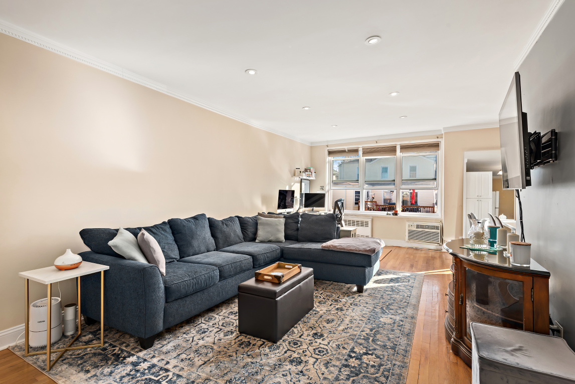 5730 Mosholu Avenue, Unit 4F Bronx, NY 10471 - Photo 2 of 15 a living room with furniture and a flat screen tv