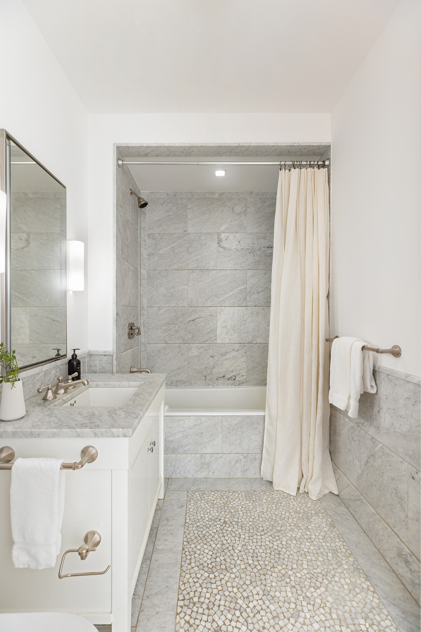 10 Madison Square West, Unit 7A Manhattan, NY 10010 - Photo 7 of 8 a bathroom with a granite countertop sink a toilet and bathtub