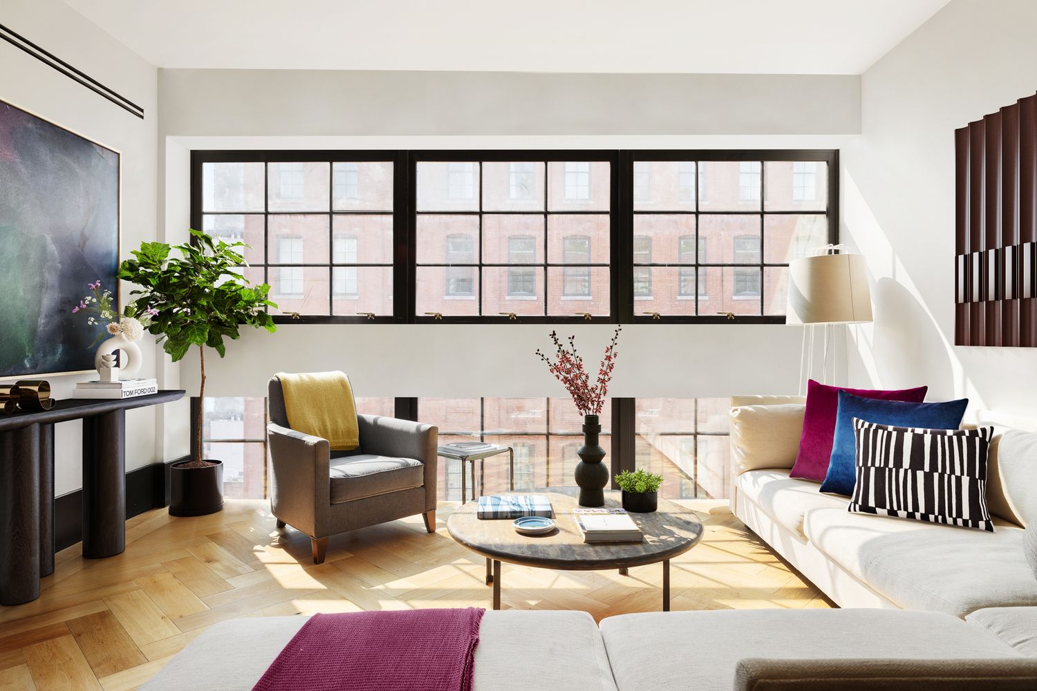a living room with furniture and a potted plant