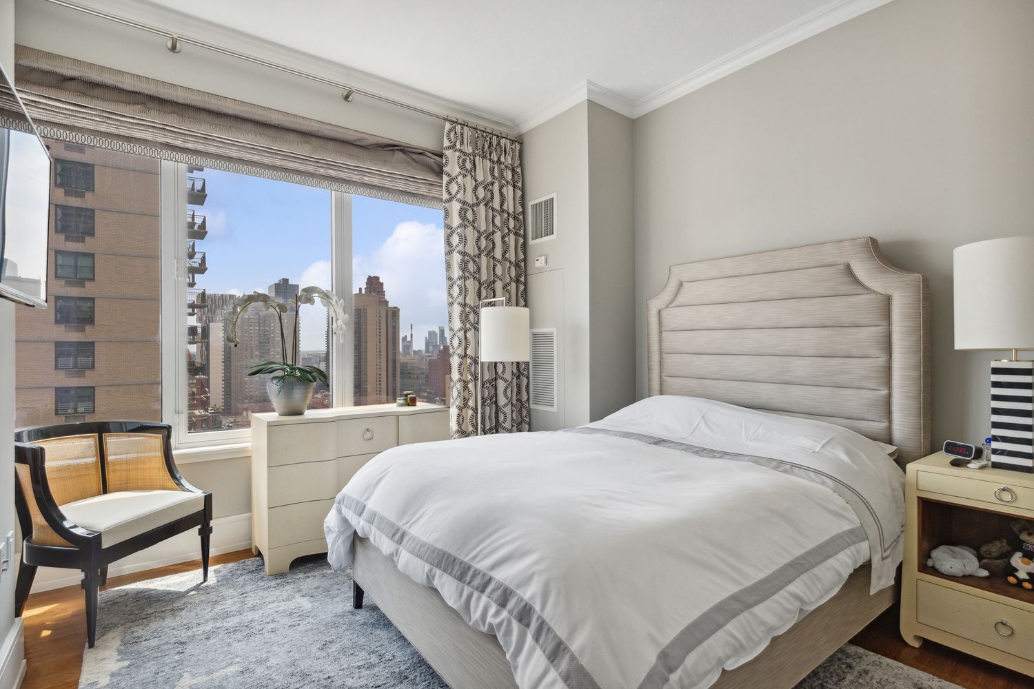 255 East 74th Street, Unit 20C Manhattan, NY 10021 - Photo 9 of 16 a bedroom with a bed and large window