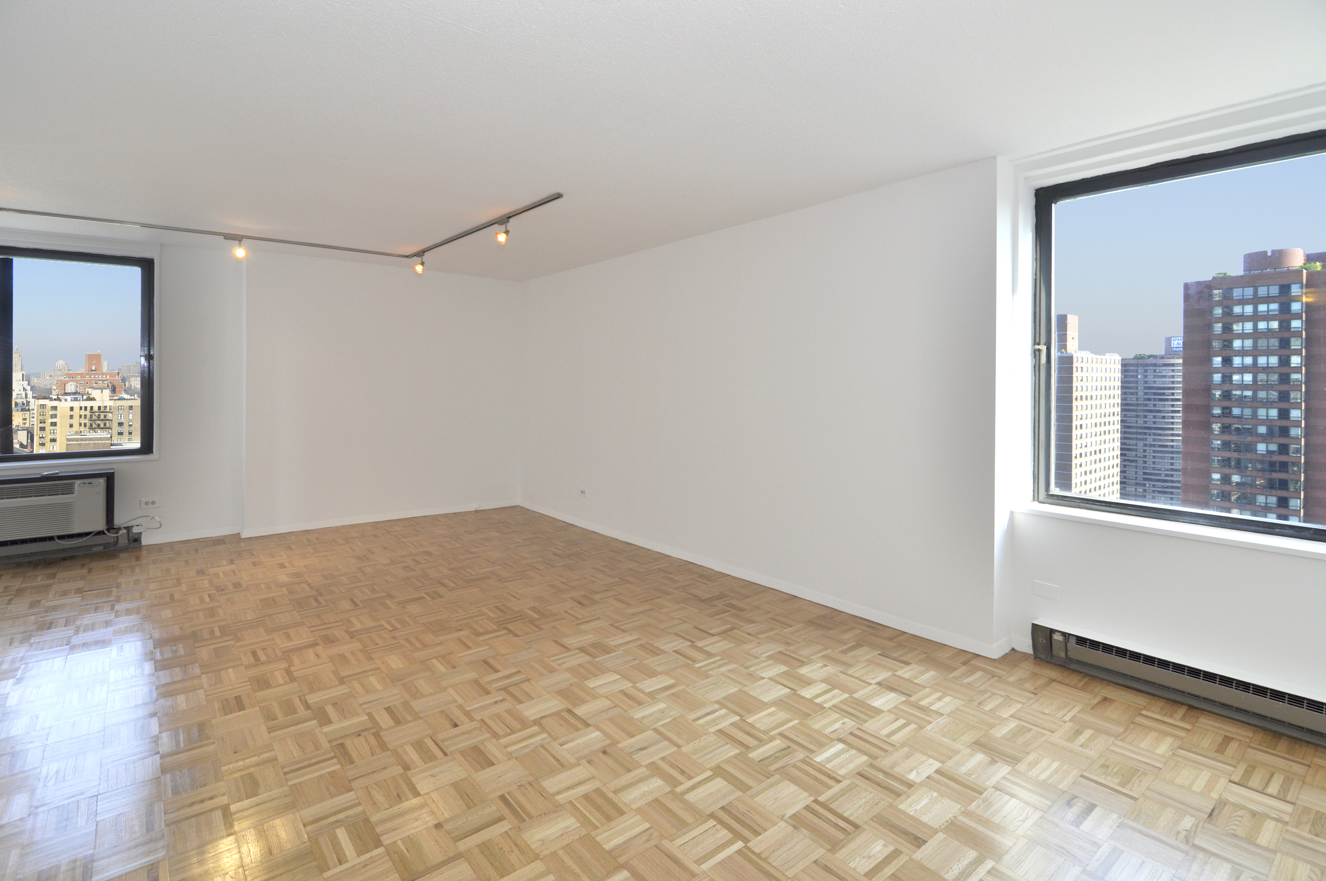 1623 3rd Avenue, Unit 25C Manhattan, NY 10128 - Photo 1 of 12 a view of empty room with wooden floor and fan
