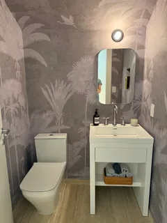a bathroom with a toilet sink and mirror