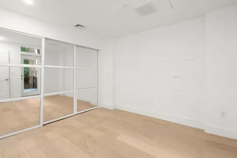 an empty room with an entryway and a window