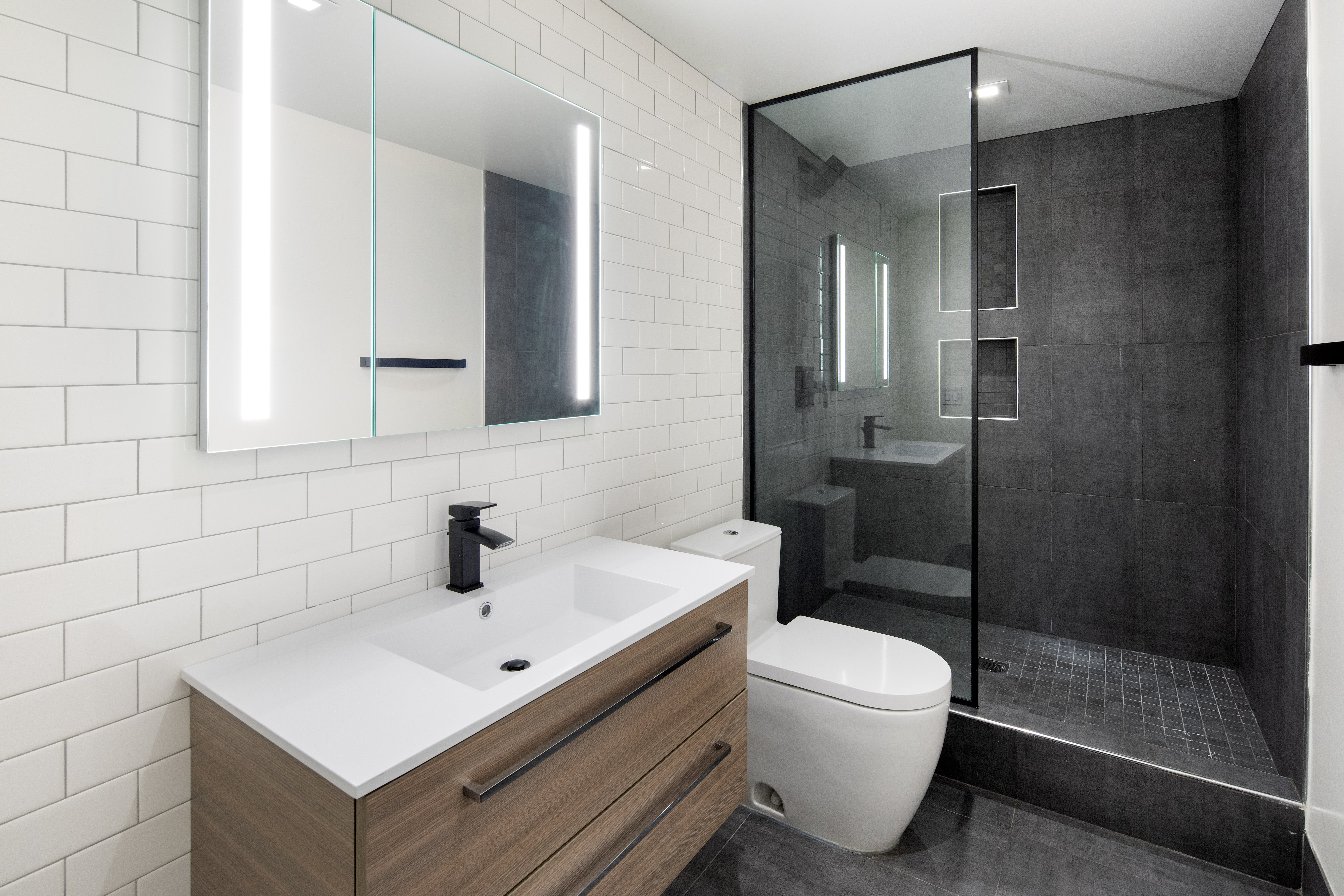 74 Leonard Street, Unit 3D Manhattan, NY 10013 - Photo 4 of 4 a bathroom with a sink toilet and shower