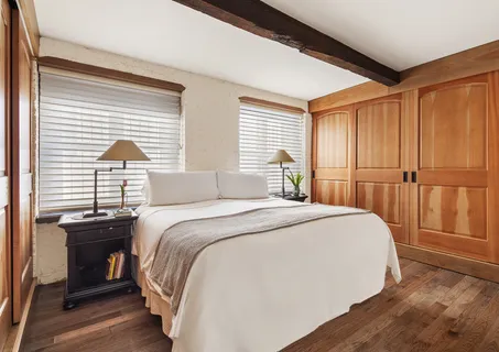 a bedroom with a bed and a table