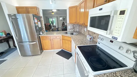 a kitchen with stainless steel appliances a refrigerator a stove a microwave and sink