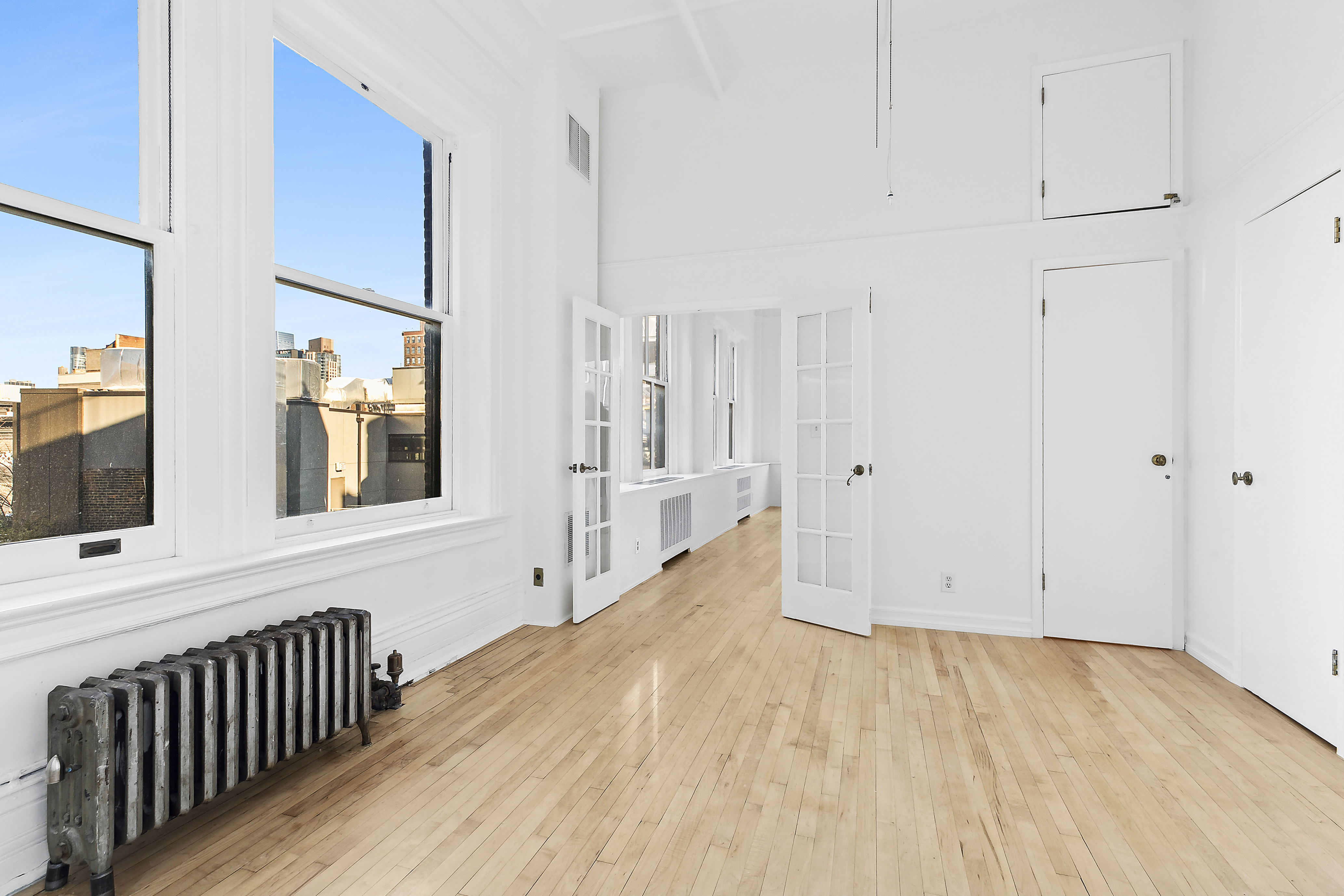 874 Broadway, Unit 907 Manhattan, NY 10003 - Photo 8 of 22 a view of a hallway with wooden floor and entryway