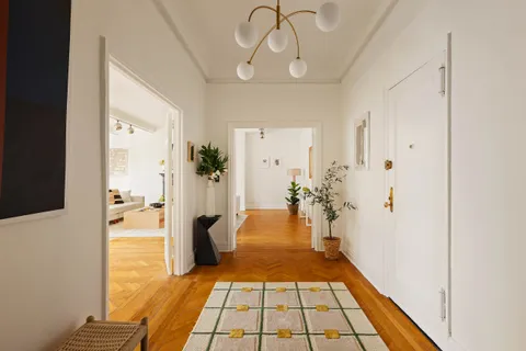 a living room with furniture large window and flat screen tv