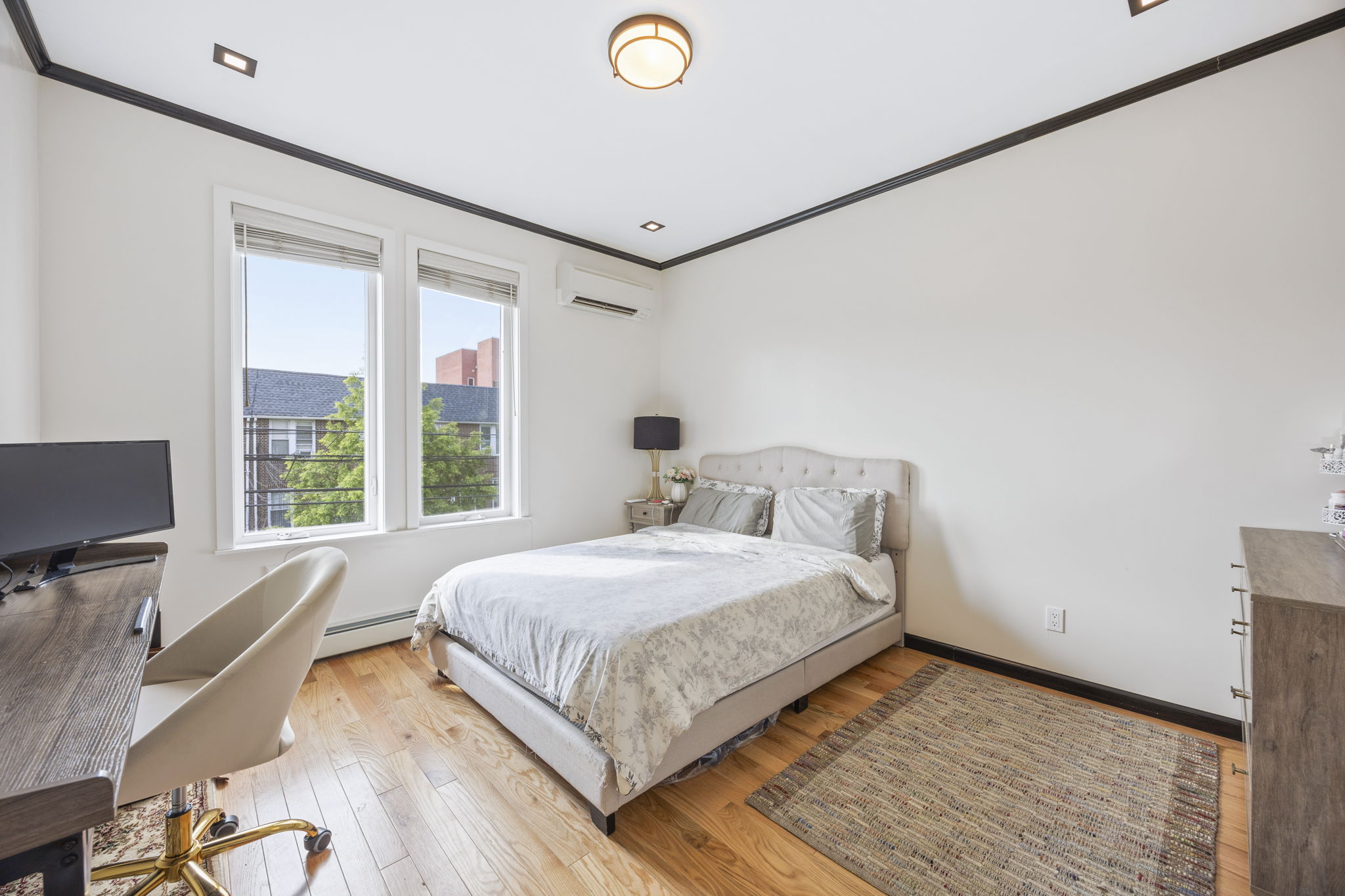 25-69 46th Street Queens, NY 11103 - Photo 15 of 33 a bedroom with a bed and a desk