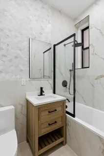 a bathroom with a sink toilet and shower