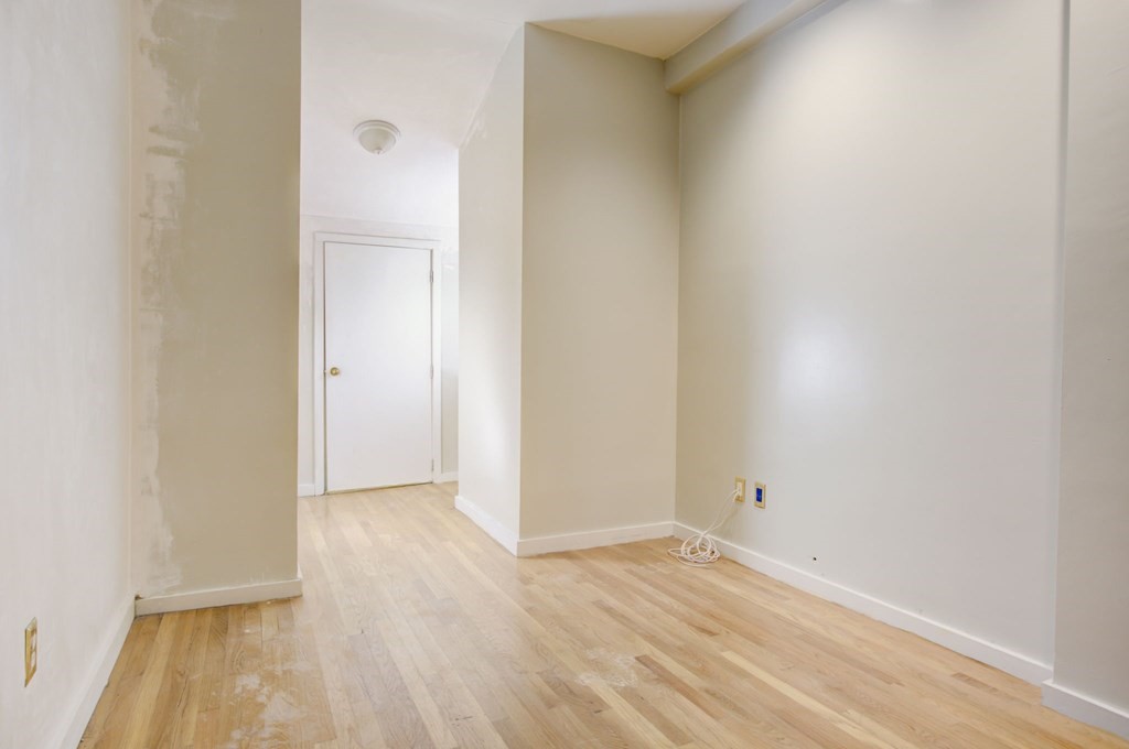 327 Commonwealth Avenue Boston, MA 02115 - Photo 23 of 26 a view of an empty room with wooden floor