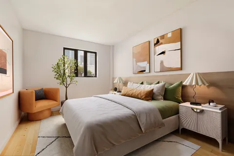 a bedroom with a bed and a couch