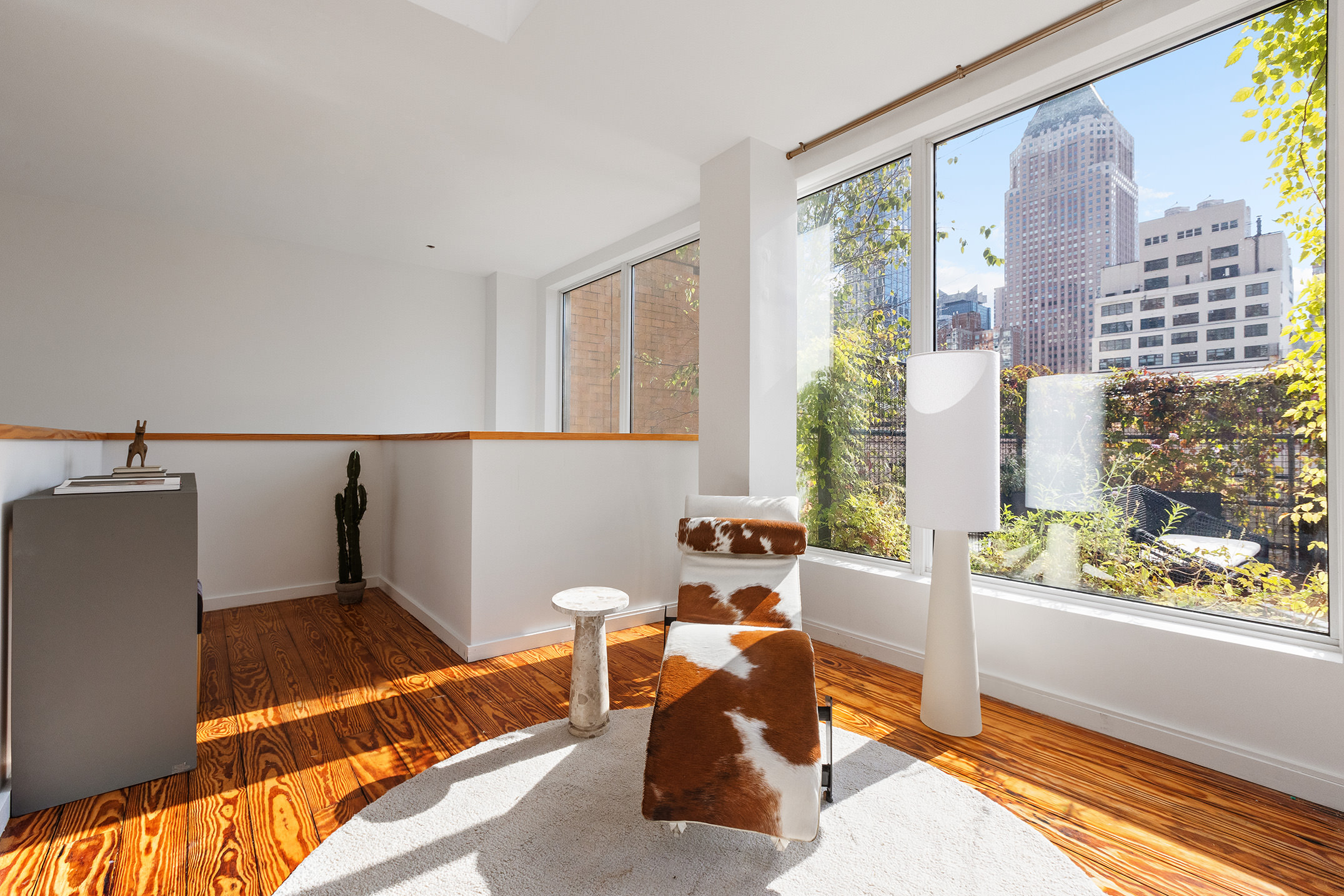 345 West 54th Street Manhattan, NY 10019 - Photo 7 of 22 a living room with furniture and a potted plant