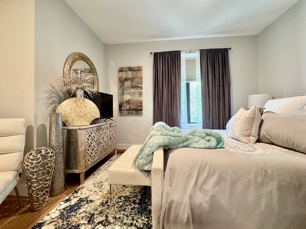 a bed sitting in a bedroom next to a window